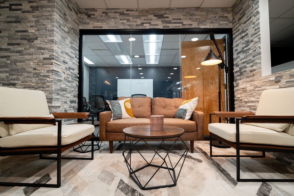 Leather and wood lounge seating beside glass