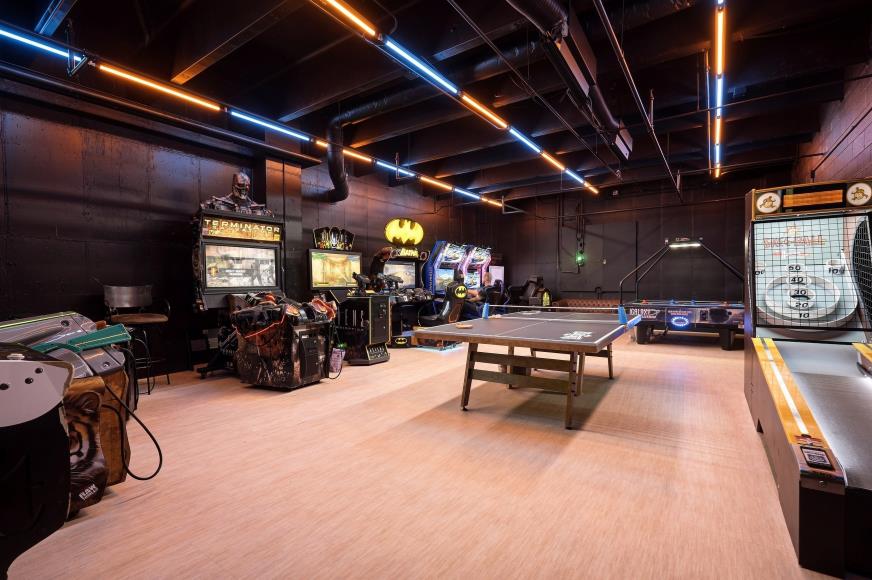 Arcade cabinets, ping pong, and games in the recreation room inside Last Look at Bear Valley Center
