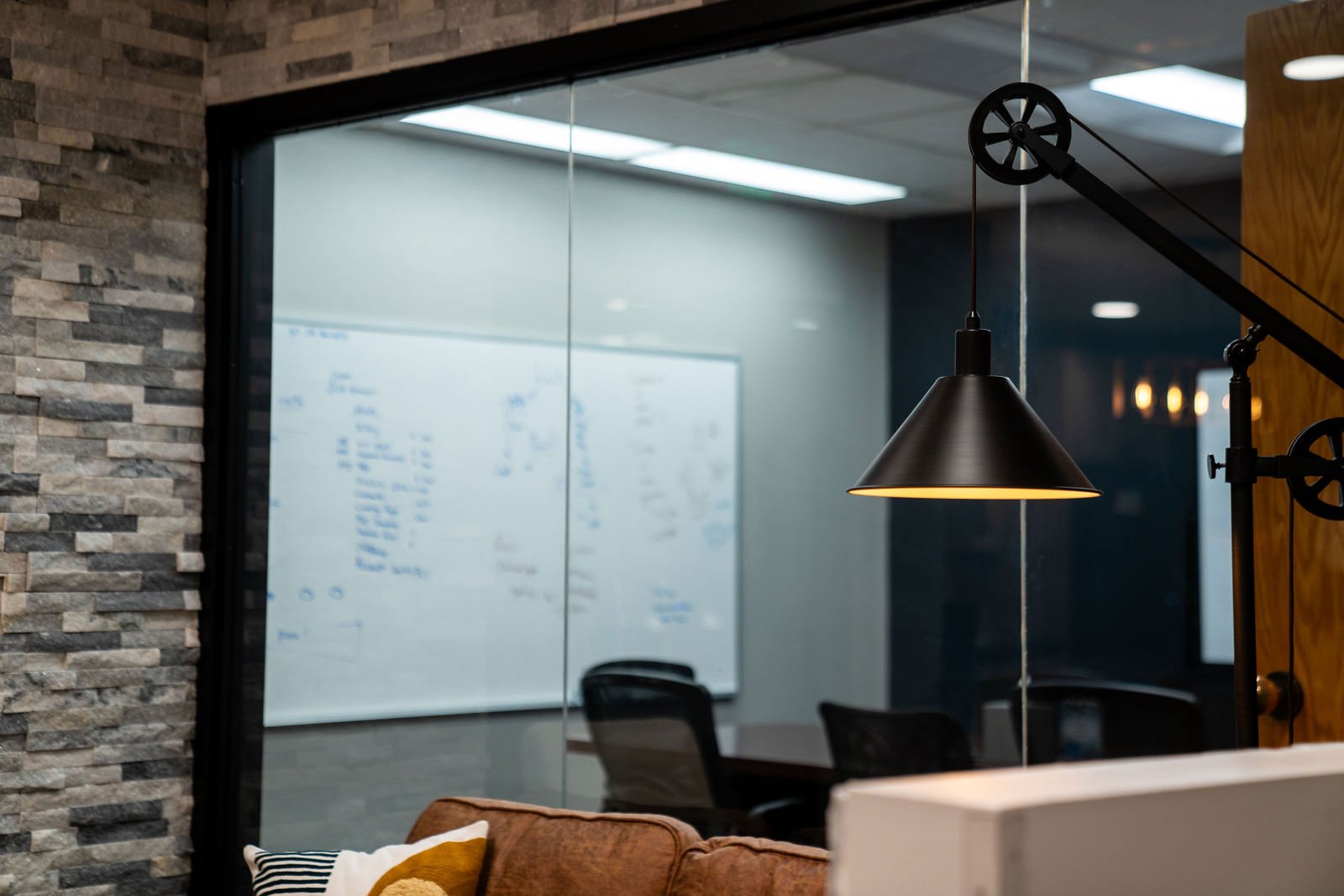 Glass-walled meeting room beside a stacked stone wall at Bear Valley Center